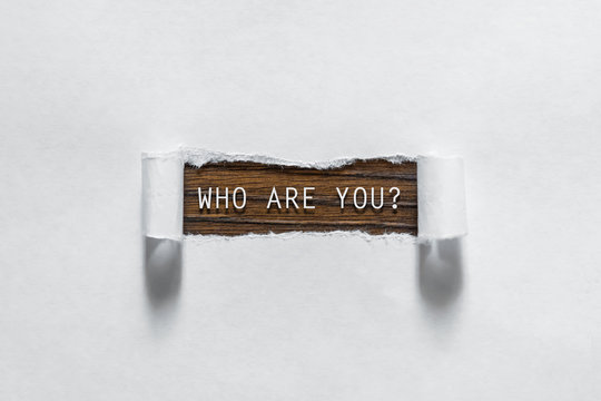 Who Are You Question Written Under Torn Paper.