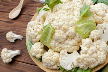 Organic cauliflower on wooden background