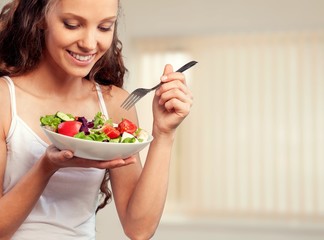 Attractive caucasian smiling woman with salad