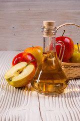 apple vinegar on a wooden rustic background