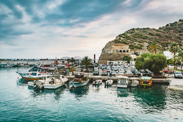 Fototapeta na wymiar Agia Galini,Crete, Greece - August, 2018: fishing boats in the harbor of agia galini on the south coast of crete, greece