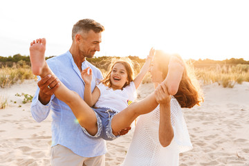 Cheerful family spending good time at the beach