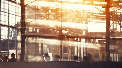 silhouettes of people walking in modern city