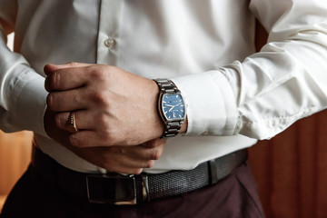 guy in the shirt adjusts the watch, accessories male look