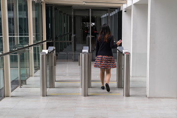 women walking to entrance gate security with key card access control smart office building