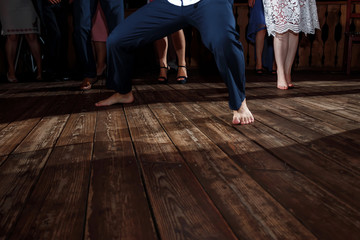 feet of people dancing on a club party. unrecognizable