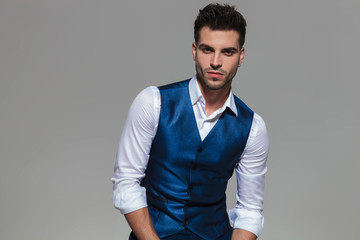 handsome young man wearing a blue waistcoast