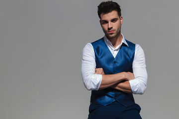 portrait of confident and elegant man wearing a blue waistcoast