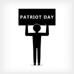 A man with a poster with the inscription Patriot Day