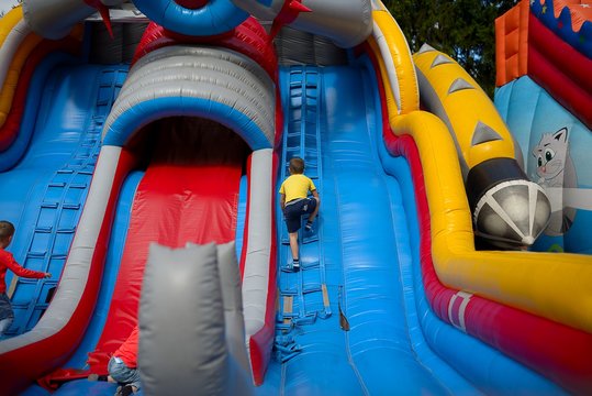 Children play on an inflatable carousel hill