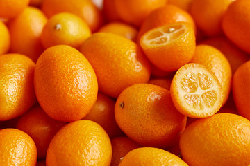 Bunch of fresh kumquats in the organic food market - obrazy, fototapety, plakaty