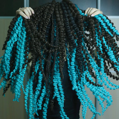 synthetic curls woven into hair in African style, voluminous hair, hairstyle, woven through brad,...