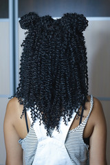 synthetic curls woven into hair in African style, voluminous hair, hairstyle, woven through brad,...
