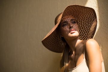 Close-up Fashion woman portrait of young pretty trendy girl in hat posing at the city, summer...