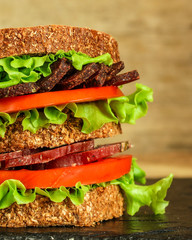 sandwich (sausage, bread, lettuce, tomatoes and more) . food background.  Top view with copy space