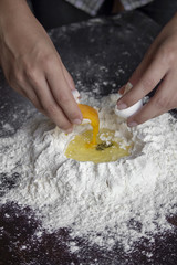 Adding egg yolk to the flour, dough preparation