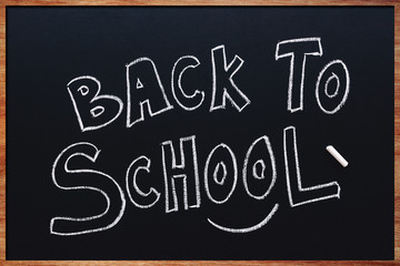 Back to School written on classroom chalkboard