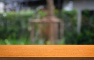 Empty dark wooden table in front of abstract blurred bokeh background of restaurant . can be used for display or montage your products.Mock up for space.