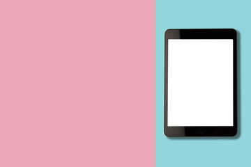 Digital tablet with blank screen on pastel color background, flat lay photo