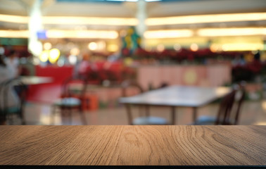 Empty dark wooden table in front of abstract blurred bokeh background of restaurant . can be used for display or montage your products.Mock up for space.