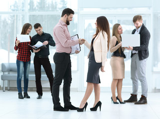 Business partners shaking hands in meeting hall