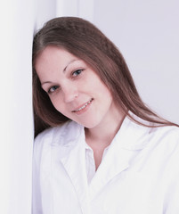 close up.beautiful young woman doctor leaning on the wall.