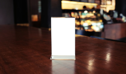 Menu frame standing on wood table in Bar restaurant cafe. space for text marketing promotion.