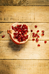 fresh pomegranate fruit on an old wooden table