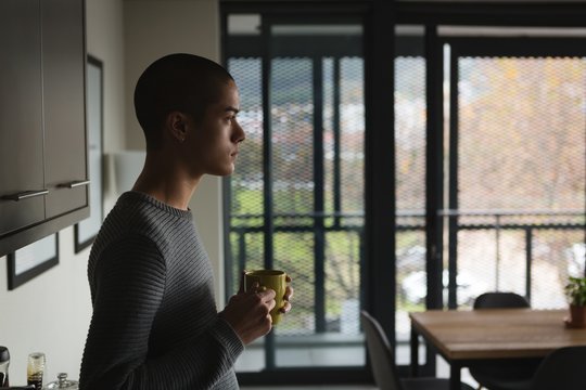 Young man having coffee at home