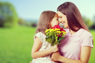 Young woman with little girl and beautiful