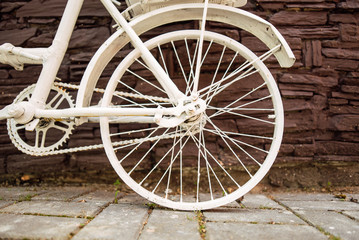 Fototapeta na wymiar Urban bicycle with a fixed mechanism on the wall background, an old bicycle. Retro-stylish cycling in the city