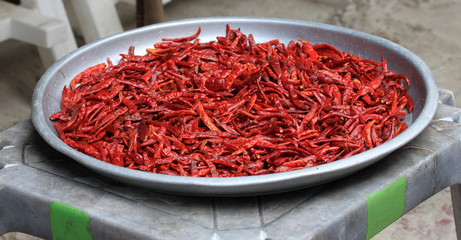 Naklejka premium Chilli. Fruits of red hot pepper on a large aluminum bowl.