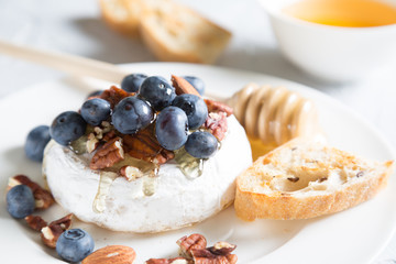 Camembert cheese with honey, nuts and fresh blueberries
