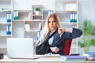 Injured female employee working in the office