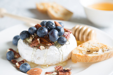 Camembert cheese with honey, nuts and fresh blueberries