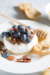 Camembert cheese with honey, nuts and fresh blueberries