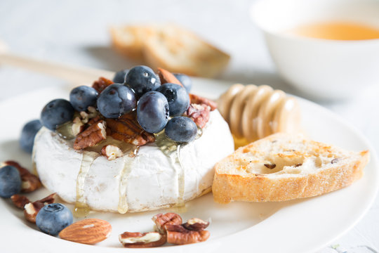 Camembert cheese with honey, nuts and fresh blueberries