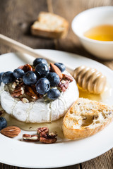 Camembert cheese with honey, nuts and fresh blueberries