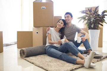 Happy young couple moving to a new house
