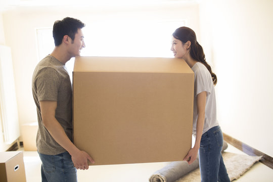 Happy Young Couple Moving To A New House