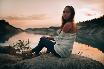 Girl on the lake at sunset