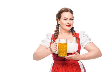 attractive oktoberfest waitress in traditional bavarian dress holding mug of light beer isolated on white background