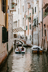 Fototapeta na wymiar Couple sailing on Venetian canal