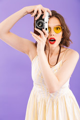 Portrait of a cheerful young woman in sunglasses