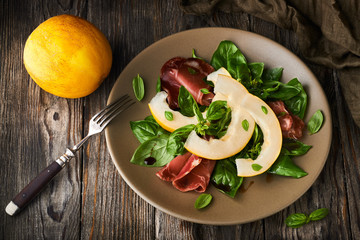 Concept of italian food with melon and prosciutto