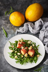 Concept of italian food with arugula, prosciutto, and melon salad