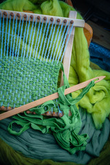 loom with greenwool for felting