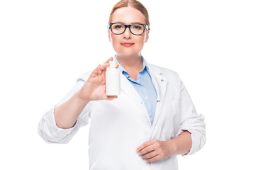smiling female doctor in eyeglasses showing pill bottle isolated on white background