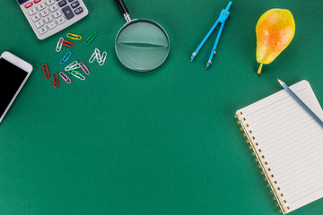 School supplies with copy space on green background