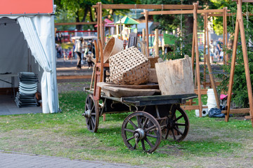 Traditional folk craftsmen market. Old horse carts with various craftsmen products.